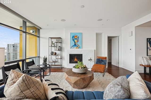 living room featuring a high end fireplace and dark hardwood / wood-style flooring