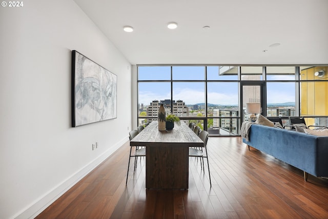 dining space with dark hardwood / wood-style flooring and floor to ceiling windows