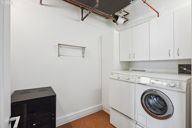 laundry room featuring cabinets, separate washer and dryer, heating unit, and hardwood / wood-style floors