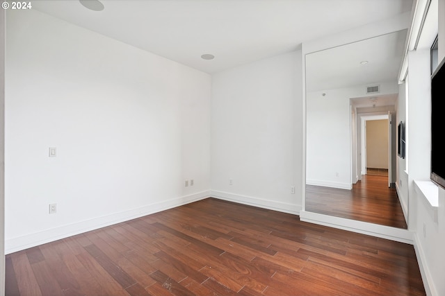 spare room featuring dark wood-type flooring