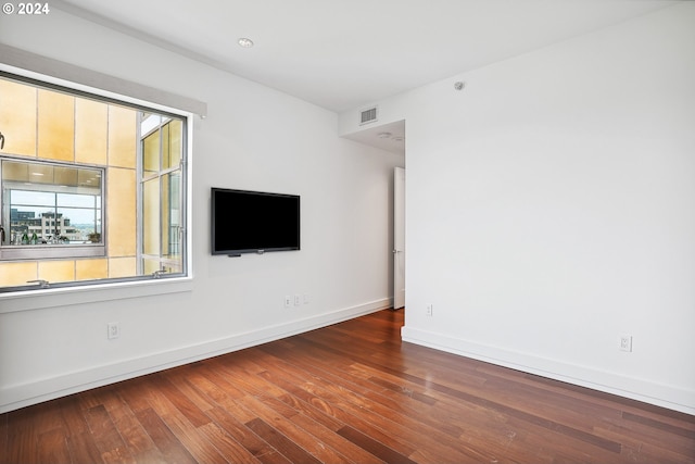 empty room with dark wood-type flooring