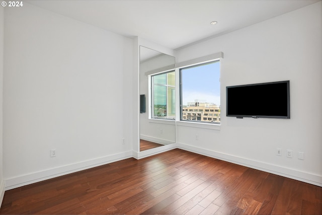 spare room with wood-type flooring