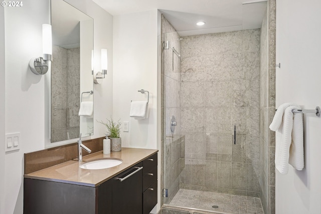 bathroom featuring vanity and a shower with door