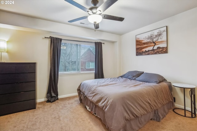 bedroom with light colored carpet and ceiling fan