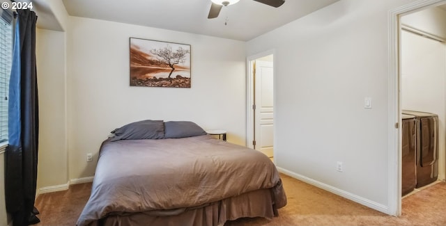 carpeted bedroom with ceiling fan and washing machine and dryer