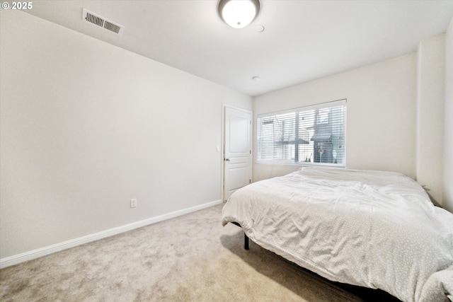 bedroom featuring light carpet