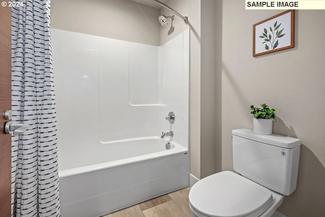 bathroom with toilet, shower / tub combo, and wood-type flooring