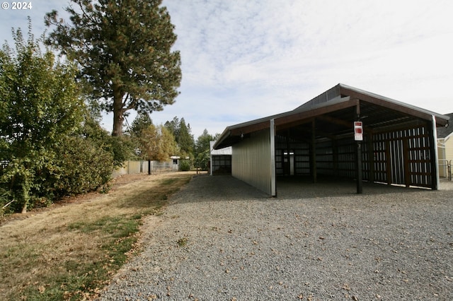 view of parking / parking lot featuring a carport