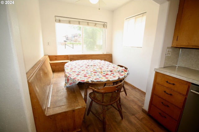 dining room with dark hardwood / wood-style flooring, ceiling fan, and plenty of natural light