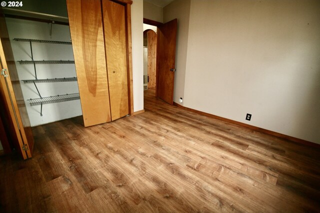 unfurnished bedroom with hardwood / wood-style floors