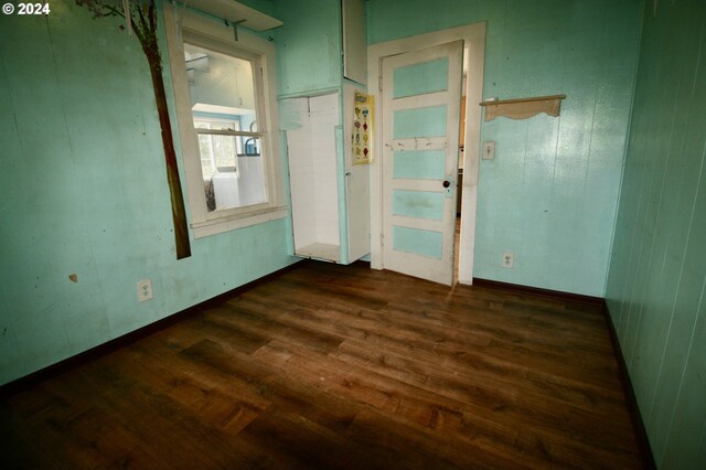 unfurnished room featuring dark wood-type flooring