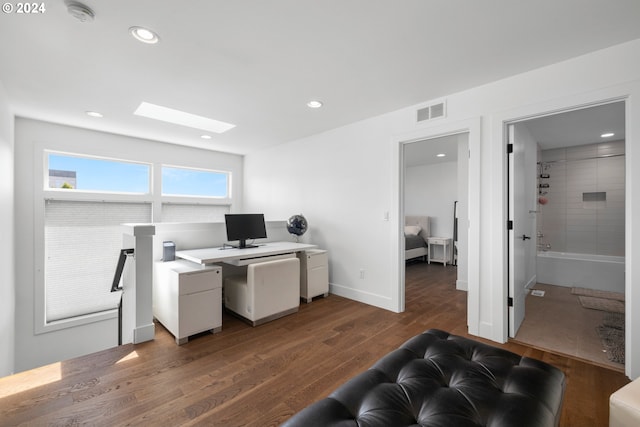 office with dark wood-type flooring and a skylight