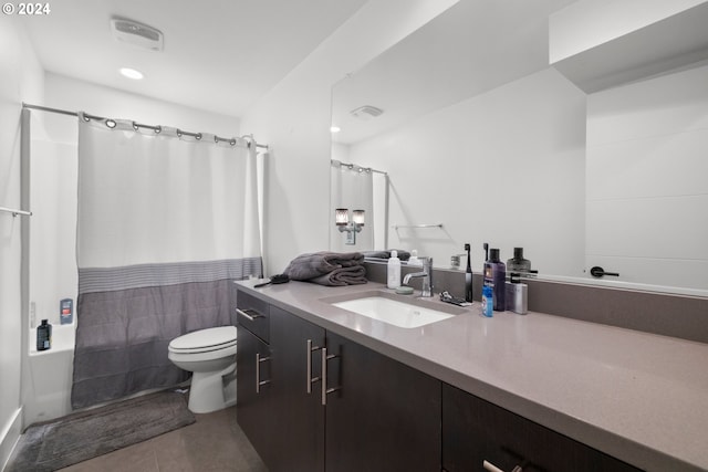 full bathroom featuring toilet, shower / bath combo, vanity, and tile patterned floors