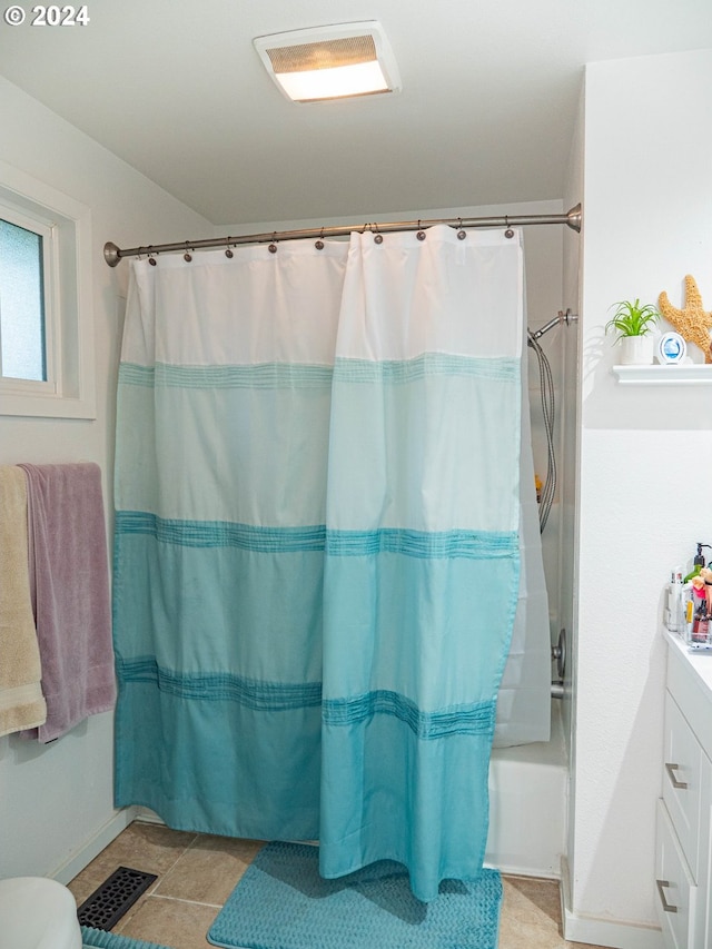 bathroom with shower / bathtub combination with curtain, tile flooring, and vanity