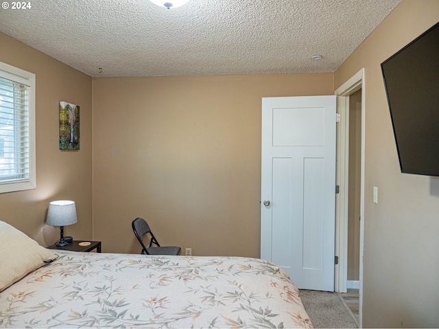 carpeted bedroom with a textured ceiling