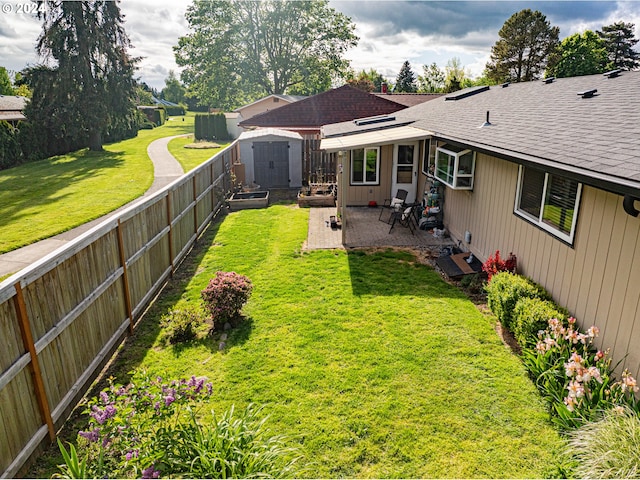 view of yard with a patio area and a storage shed