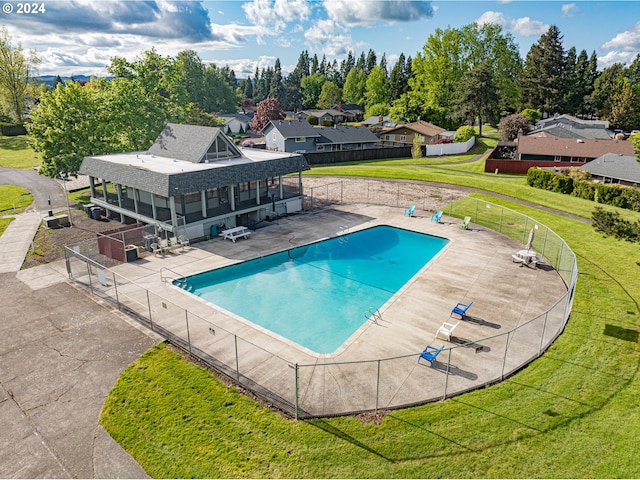 view of swimming pool featuring a lawn and a patio area