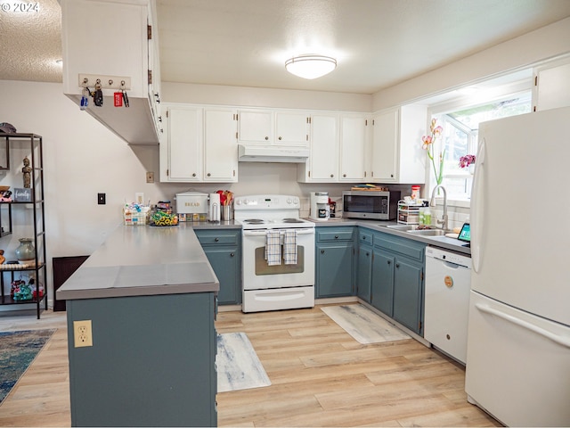 kitchen with light hardwood / wood-style flooring, white appliances, white cabinets, sink, and blue cabinets