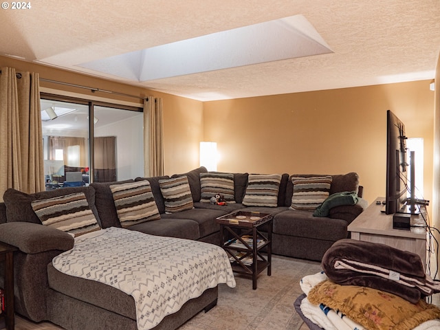 carpeted living room featuring a textured ceiling