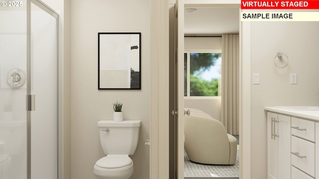 bathroom featuring an enclosed shower, vanity, and toilet