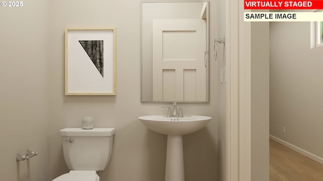 bathroom featuring toilet and hardwood / wood-style flooring