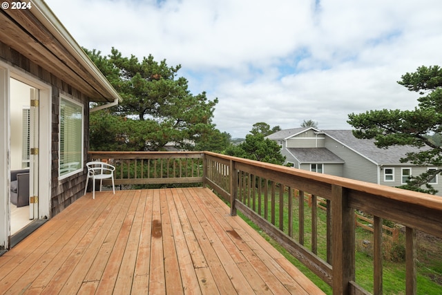 wooden terrace featuring a lawn