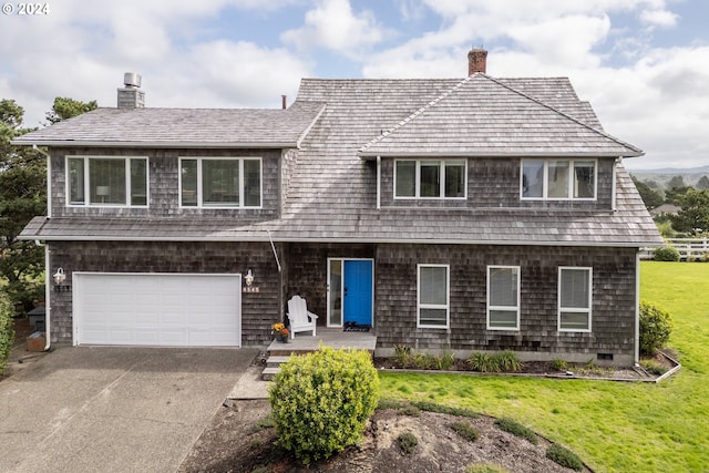 view of front facade with a front yard and a garage