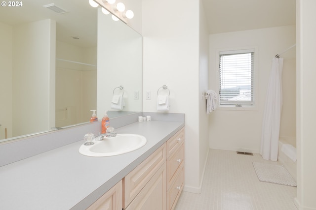 bathroom with vanity, tile patterned floors, and shower / bath combo