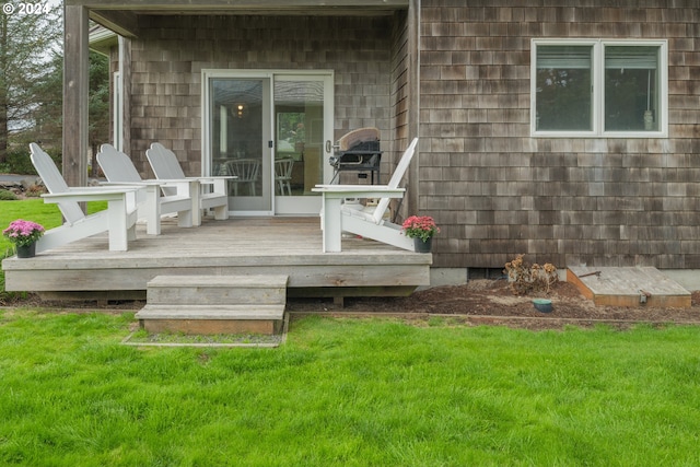 wooden terrace featuring a yard