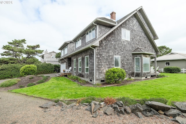 view of side of home with a lawn