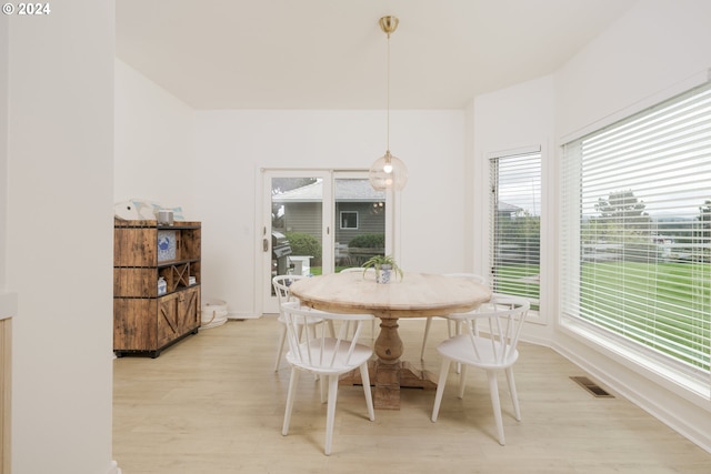 dining room with a healthy amount of sunlight and light wood-type flooring