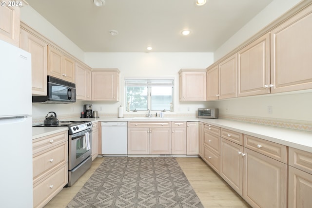 kitchen featuring light hardwood / wood-style flooring, sink, and white appliances