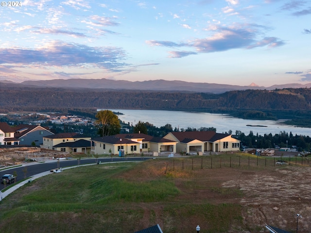 aerial view at dusk with a water and mountain view