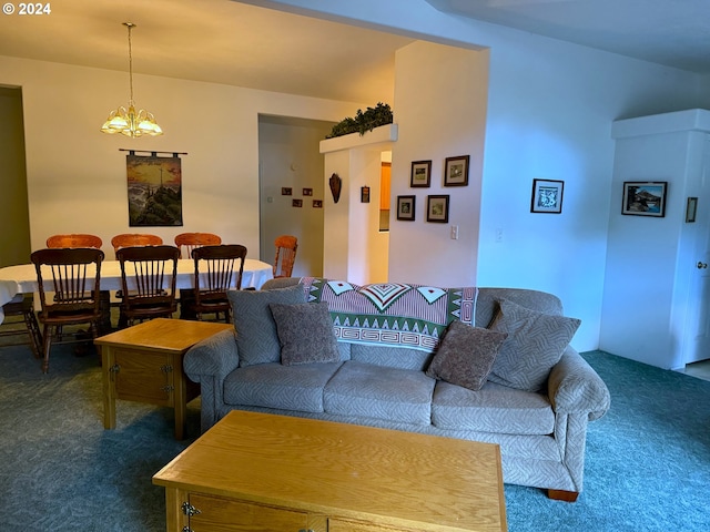 living room featuring dark carpet and a chandelier