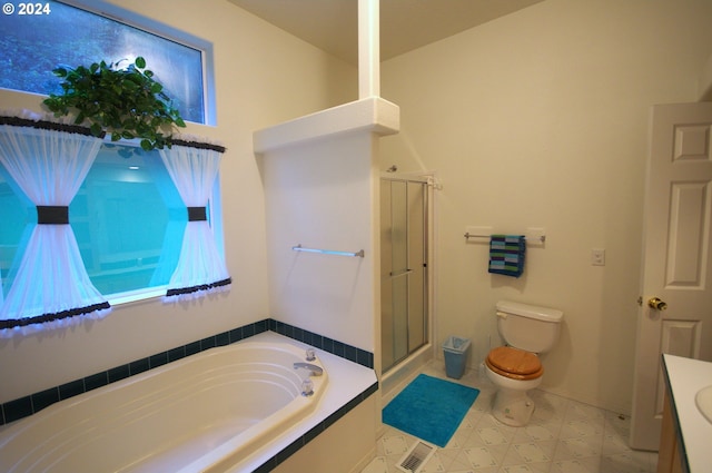 bathroom with toilet and shower with separate bathtub