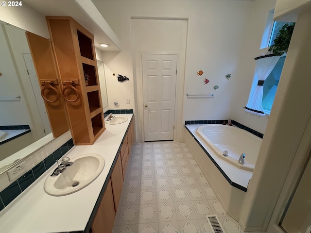 bathroom with tasteful backsplash, vanity, and a bathing tub