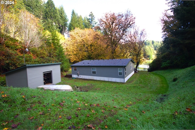 exterior space featuring a lawn and an outdoor structure