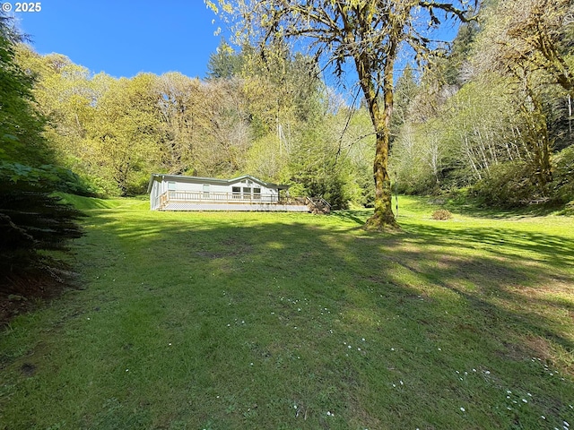 2647 S Tenmile, Lakeside, OR 97449 - view of green lawn featuring a wooden deck and a wooded view