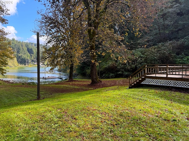 view of yard featuring a deck with water view