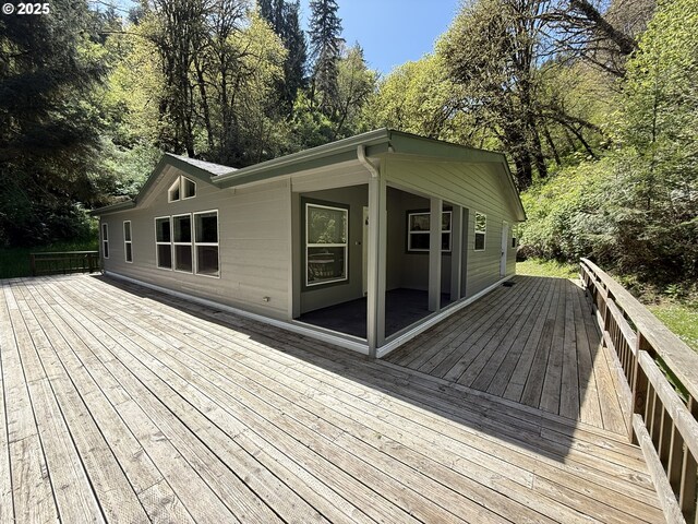 2647 S Tenmile, Lakeside, OR 97449 - wooden deck featuring view of wooded area