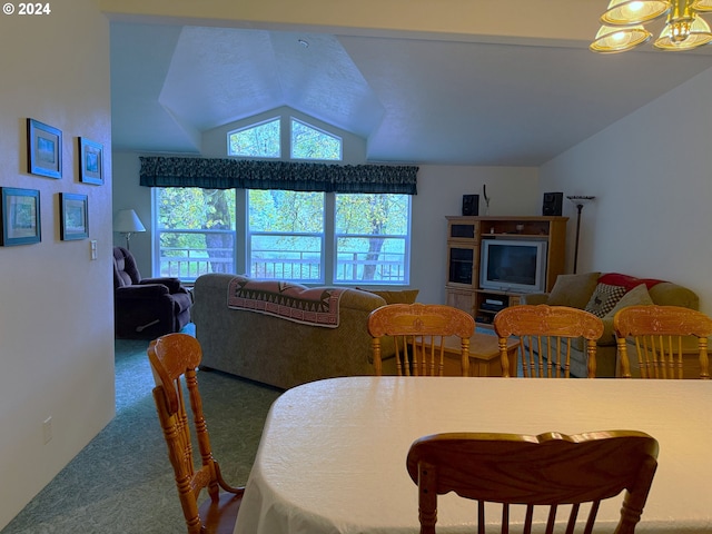 carpeted dining room featuring lofted ceiling