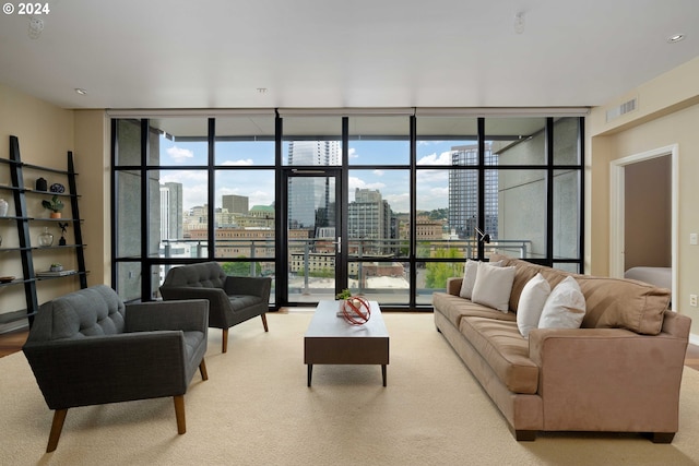 living room featuring light carpet, floor to ceiling windows, and a healthy amount of sunlight