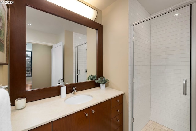 bathroom with walk in shower and vanity