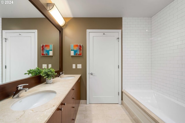 bathroom with tile patterned flooring, a tub, and vanity