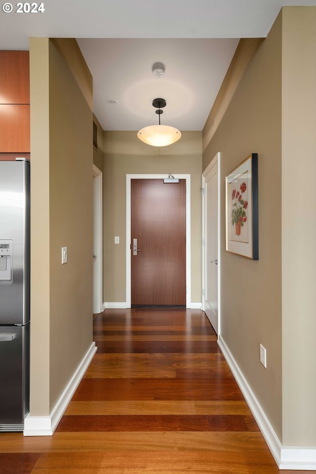 hallway with dark hardwood / wood-style floors