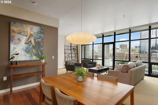 dining area with expansive windows and wood-type flooring