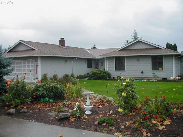 single story home featuring a garage, a shingled roof, a chimney, and a front yard