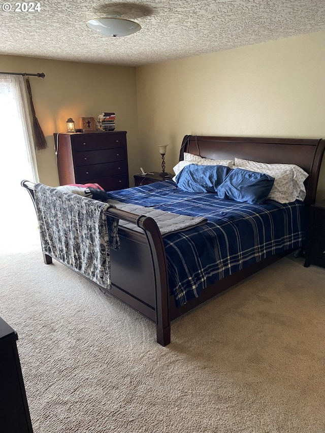 carpeted bedroom featuring a textured ceiling