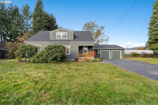 view of front of property featuring a front lawn, covered porch, and a garage