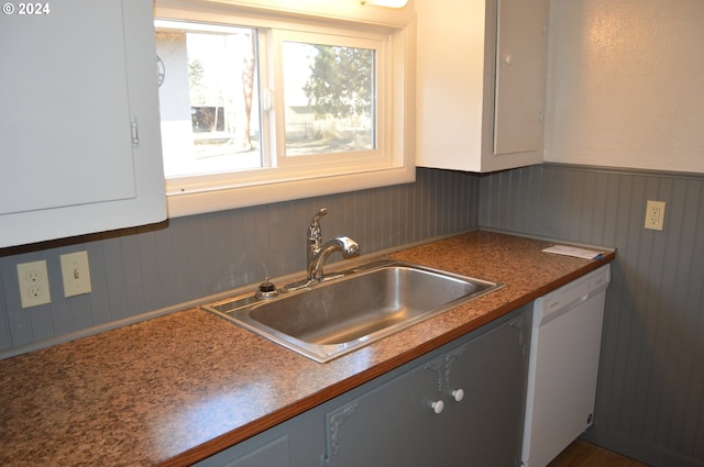 705 Couch Ave, Wallowa, OR 97885 - kitchen with dishwasher, a sink, and a wainscoted wall